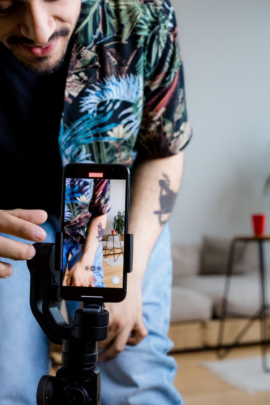 Man filming short-form video content on a smartphone
